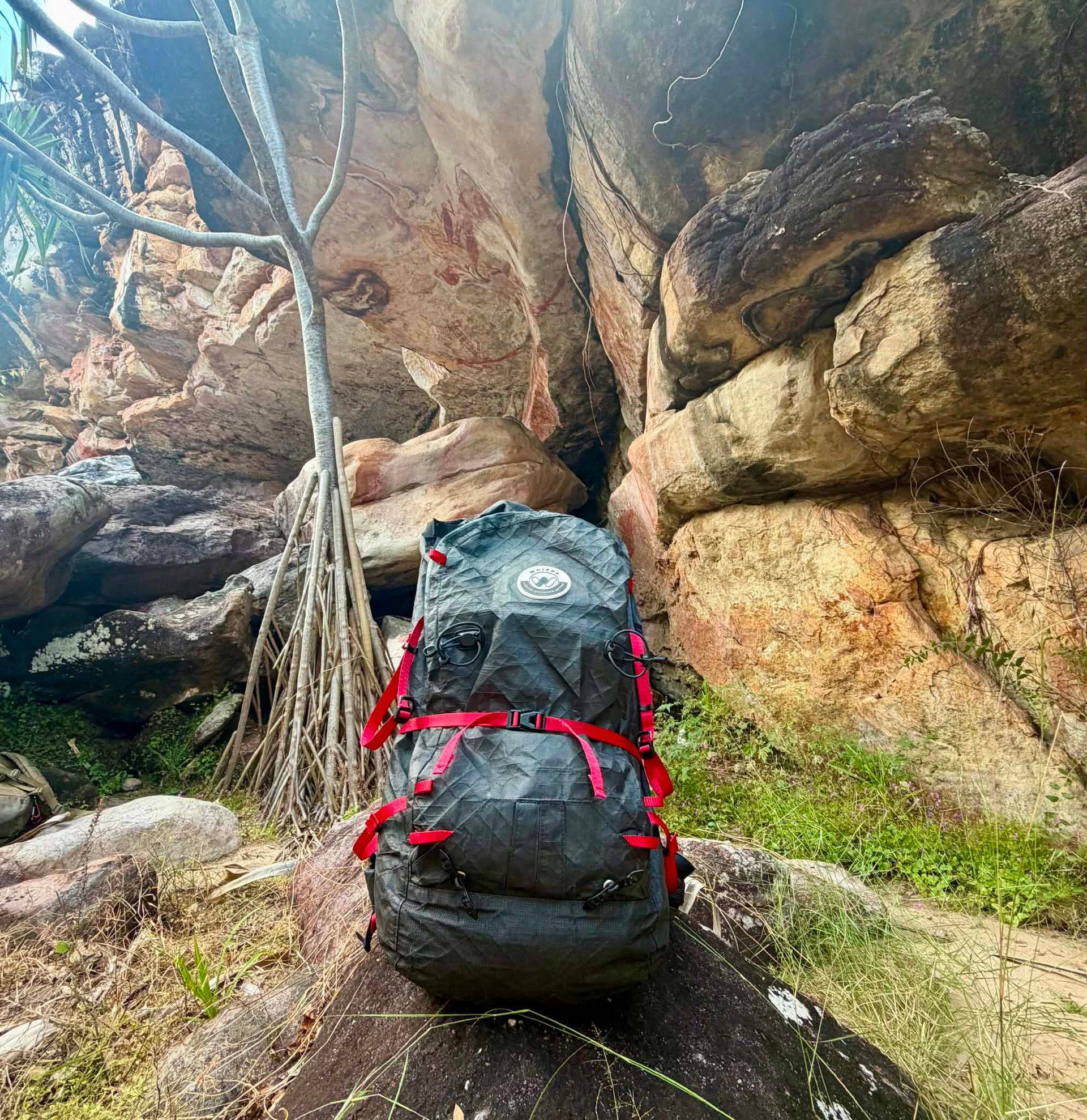 Whippa backpack with red straps among sandstone rocks